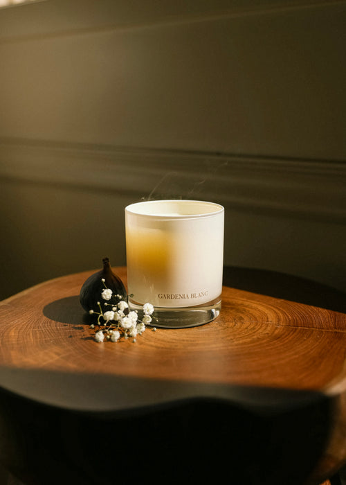 CHENDA STUDIO No. 02 Gardenia Blanc candle styled with white flowers on a wooden table in warm light